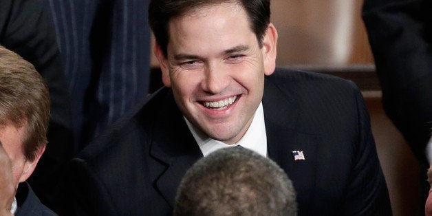 WASHINGTON, DC - JANUARY 28: U.S. President Barack Obama greets U.S. Sen Marco Rubio (R-FL) (top) before delivering the State of the Union address to a joint session of Congress in the House Chamber at the U.S. Capitol on January 28, 2014 in Washington, DC. In his fifth State of the Union address, Obama is expected to emphasize on healthcare, economic fairness and new initiatives designed to stimulate the U.S. economy with bipartisan cooperation. (Photo by Win McNamee/Getty Images)