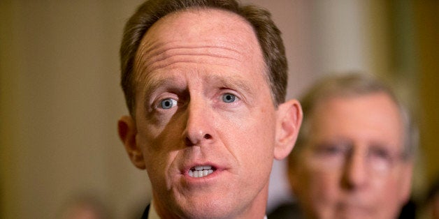 Sen. Pat Toomey, R-Pa., joined by Senate Minority Leader Mitch McConnell, R-Ky., right, speaks with reporters after a GOP str