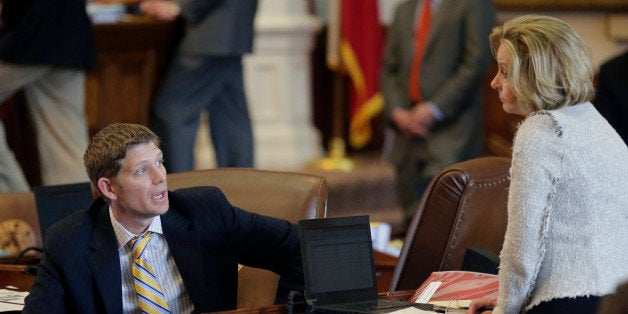 Texas Rep. Matt Krause, R- Fort Worth, left, talks with Rep. Geanie Morrison, R-Victoria, right, in the House Chamber, Wednesday, May 13, 2015, in Austin, Texas. Morrison has proposed a bill making it more difficult for girls younger than 18 who face extreme circumstances to have abortions without their parents' consent. (AP Photo/Eric Gay)