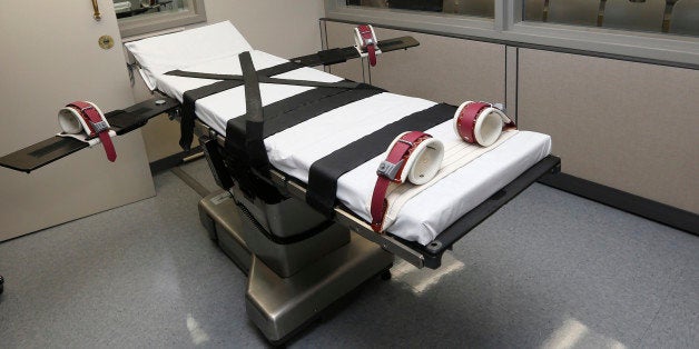 FILE - In this Thursday, Oct. 9, 2014 photo, the gurney in the the execution chamber at the Oklahoma State Penitentiary is pictured in McAlester, Okla. Oklahoma plans to resume executions Thursday, Jan. 15, 2015, after botching its last one and will use the same three-drug method as a Florida lethal injection scheduled for the same day. (AP Photo/Sue Ogrocki, File)