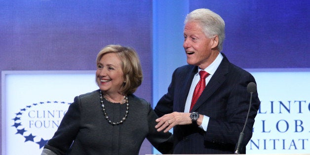 Former Secretary of State Hillary Rodham Clinton and former U.S. President Bill Clinton appear together on stage during a plenary session at the Clinton Global Initiative, Monday, Sept. 22, 2014 in New York. (Photo by Greg Allen/Invision/AP)