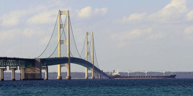 A ship is seen passing beneath the Mackinaw Bridge July 27, 2008 as seen from Mackinaw City, MI.The Mackinac Bridge straddles the Straits of Mackinac connecting Michigan's upper and lower peninsulas. Building it took three years, 2,500 men, 85,000 blueprints, 71,300 tons of structural steel, 466,3000 cubic yards of concrete, 41,000 miles of cable wire and millions of steel rivets and bolts. AFP PHOTO/Karen BLEIER (Photo credit should read KAREN BLEIER/AFP/Getty Images)