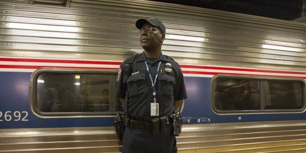 An Amtrak police officer stands guard outside Train 110, Monday, May 18, 2015, at Philadelphia's 30th Street Station. The train bound for New York's Penn Station was the first northbound train from the city since a May 12 derailment killed 8 people and injured dozens. (AP Photo/Michael R. Sisak)