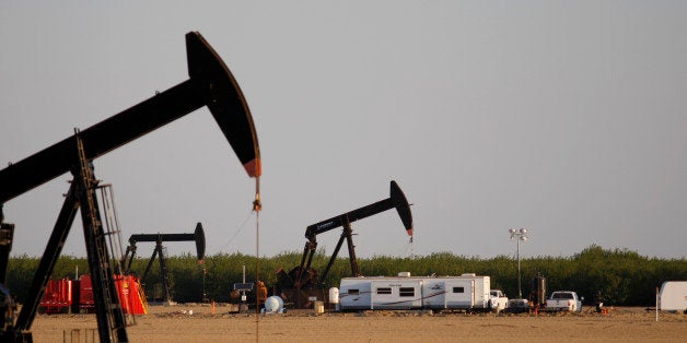 LOST HILLS, CA - MARCH 24: A pump jack and frac tanks stand in field being developed for drilling next to a farm over the Monterey Shale formation where gas and oil extraction using hydraulic fracturing, or fracking, is on the verge of a boom on March 24, 2014 near Lost Hills, California. Critics of fracking in California cite concerns over water usage and possible chemical pollution of ground water sources as California farmers are forced to leave unprecedented expanses of fields fallow in one of the worst droughts in California history. Concerns also include the possibility of earthquakes triggered by the fracking process which injects water, sand and various chemicals under high pressure into the ground to break the rock to release oil and gas for extraction though a well. The 800-mile-long San Andreas Fault runs north and south on the western side of the Monterey Formation in the Central Valley and is thought to be the most dangerous fault in the nation. Proponents of the fracking boom saying that the expansion of petroleum extraction is good for the economy and security by developing more domestic energy sources and increasing gas and oil exports. (Photo by David McNew/Getty Images)