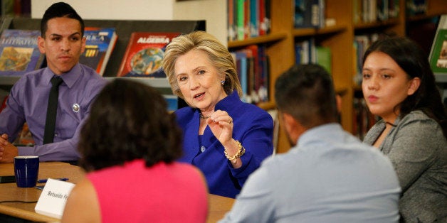 Democratic presidential candidate Hillary Rodham Clinton speaks with a group, including students, about immigration during a round at an event at Rancho High School Tuesday, May 5, 2015, in Las Vegas. (AP Photo/John Locher)