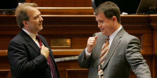 FILE - In this Thursday, May 21, 2009 file photo, Sen. Lee Bright, R-Spartanburg, right, holds onto the microphone as Sen. Brad Hutto, D-Orangeburg, objects to the disruptions during the last day of the legislative session as they were dealing with the governors budget vetoes at the Statehouse in Columbia, S.C. Bright thinks America is at a vital crossroads and must make the right decisions to survive. The Spartanburg County lawmaker's political career seems to be at a similar juncture, as he decides whether to cash in on his conservative credentials and take on U.S. Sen. Lindsey Graham in the 2014 Republican primary. (AP Photo/Mary Ann Chastain, File)