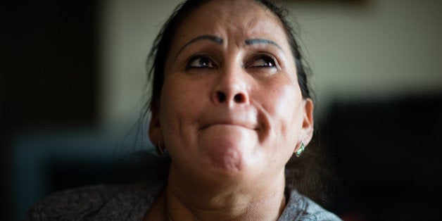 MANASSAS, VA - FEBRUARY 28: Salvadoran immigrant, Adelia Aguilar, 54, might be eligible for a green card as a result of President Barack Obama's executive action on immigration. She is pictured in her Manassas, VA apartment where she lives with her two U.S. born teenage children. Aguilar is exhausted after coming home from her job at a restaurant where she started at five in the morning. She has a second job taking care of seniors. (Sarah L. Voisin/The Washington Post via Getty Images)