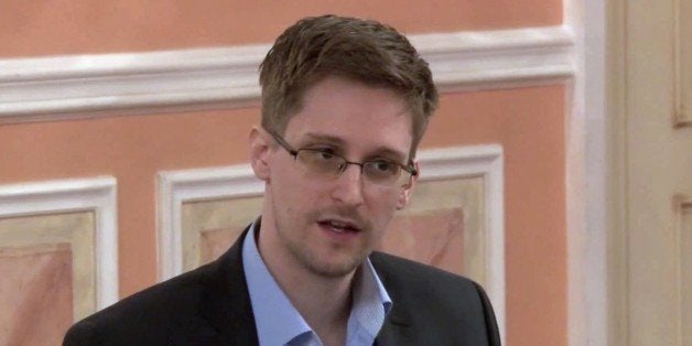 In this image made from video released by WikiLeaks on Friday, Oct. 11, 2013, former National Security Agency systems analyst Edward Snowden speaks during a presentation ceremony for the Sam Adams Award in Moscow, Russia. Should Snowden ever return to the U.S., he would face criminal charges for leaking information about NSA surveillance programs. But legal experts say a trial could expose more classified information as his lawyers try to build a case in an open court that the operations he exposed were illegal. (AP Photo)