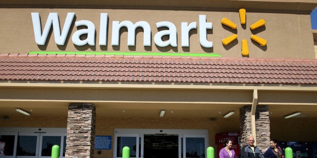 MIAMI, FL - FEBRUARY 19: Walmart customers exit from the store on February 19, 2015 in Miami, Florida. The Walmart company