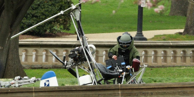 WASHINGTON, DC - APRIL 15: A member of the U.S. Capitol Police Bomb Squad works to check and secure a gyrocopter that landed on the West Front of the U.S. Capitol April 15, 2015 in Washington, DC. Doug Hughes, a 61-year-old postal worker from Ruskin, Florida, landed the lightweight helicopter on the Capitol lawn to protest against government corruption and to promote campaign finance reform. (Photo by Chip Somodevilla/Getty Images)