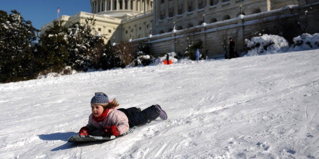 Children sled down Capitol Hill in Washington, DC on February 8, 2010 as the District of Columbia and the mid-Atlantic region recover from a weekend blizzard that droped more than two feet of snow (about 75 cm) on the capital. The Federal Government closed today along with schools and many businesses. AFP PHOTO / Tim SLOAN (Photo credit should read TIM SLOAN/AFP/Getty Images)