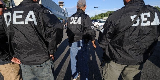 DEA agents wait for the arrival of Jamaican gang leader Christopher "Dudus" Coke From Westchester County Airport, Thursday, June 24, 2010, in White Plains, New York. (AP Photo/Louis Lanzano)