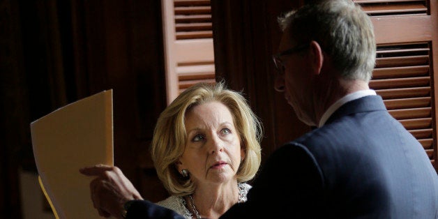 Texas Rep. Geanie Morrison, R-Victoria, left, talks with Rep. Byron Cook, R-Corsicana, right, in the House Chamber, Wednesday, May 13, 2015, in Austin, Texas. Morrison has proposed a bill making it more difficult for girls younger than 18 who face extreme circumstances to have abortions without their parents' consent. (AP Photo/Eric Gay)