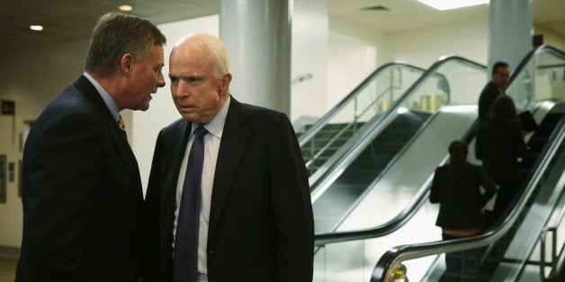 WASHINGTON, DC - APRIL 23: U.S. Sen. John McCain (R-AZ) (R) listens to Sen. Richard Burr (R-NC) (L) after a vote on Loretta