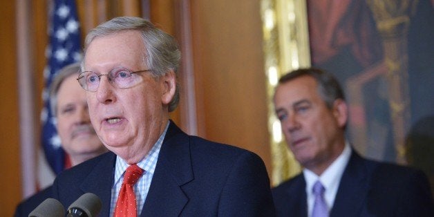 Senate Majority Leader Mitch McConnell, R-KY, speaks during a signing ceremony for the Keystone XL Pipeline Approval Act on February 13, 2015 in the Rayburn Room of the US Capitol in Washington, DC. From left: Senator John Hoeven, R-ND, and House Speaker John Boehner, R-OH. AFP PHOTO/MANDEL NGAN (Photo credit should read MANDEL NGAN/AFP/Getty Images)