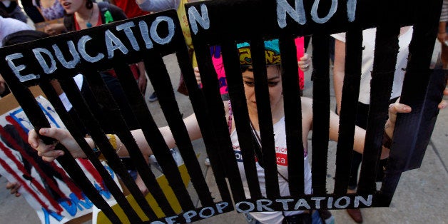 Jovanna Hernandez carries a sign during a protest march in support of undocumented youth, which concluded in front of the U.S. Immigration and Customs Enforcement office Wednesday, March 14, 2012 in Philadelphia. (AP Photo/Alex Brandon)