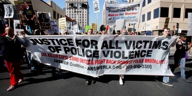 Protestors calling for the end of police brutality marched through downtown Sacramento, Calif., Tuesday, Oct. 22, 2013. Calling it an epidemic of police brutality, organizers of the demonstration called for the drug testing of officers after officer-involved shootings, for body cameras to be worn by every officer, and other demands. (AP Photo/Rich Pedroncelli)