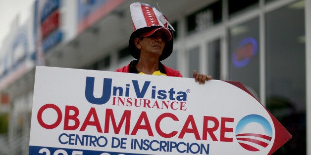 MIAMI, FL - FEBRUARY 05: Oreste Alvarez holds a sign directing people to UniVista Insurance company where they can sign up for the Affordable Care Act, also known as Obamacare, before the February 15th deadline on February 5, 2015 in Miami, Florida. Numbers released by the government show that the Miami-Fort Lauderdale-West Palm Beach metropolitan area has signed up 637,514 consumers so far since open enrollment began on Nov. 15, which is more than twice as many as the next large metropolitan area, Atlanta, Georgia. (Photo by Joe Raedle/Getty Images)