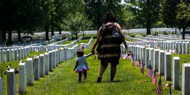 ARLINGTON, VA - MAY 25: A mother and daughter stand in Section 60 on Memorial Day at Arlington National Cemetery on May 25,