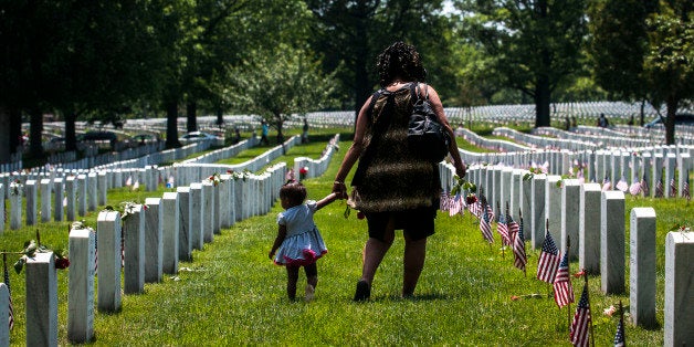 ARLINGTON, VA - MAY 25: A mother and daughter stand in Section 60 on Memorial Day at Arlington National Cemetery on May 25, 2015 in Arlington, Va. U.S. President Barack Obama, Chairman of the Joint Chiefs of Staff U.S. Army General Martin Dempsey and U.S. Defense Secretary Ash Carter honored fallen soldiers during a ceremony at Arlington on this Memorial Day. (Photo by Gabriella Demczuk/Getty Images)