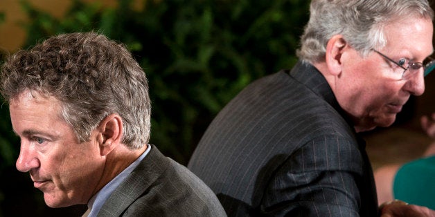 Senator Rand Paul(L) R-KY and Senate Minority Leader Senator Mitch McConnell (R-KY) wait for an event in the East Room of the White House July 23, 2013 in Washington, DC. Obama attended the event with the Louisville Cardinals to honor their 2013 NCAA Mens Basketball Champion win. AFP PHOTO/Brendan SMIALOWSKI (Photo credit should read BRENDAN SMIALOWSKI/AFP/Getty Images)