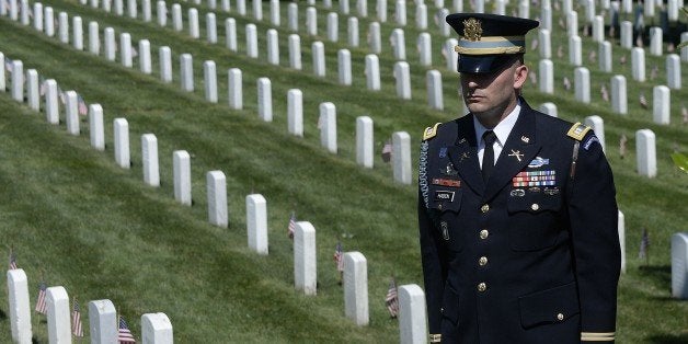 ARLINGTON, VA - MAY 25: A member of the honor guard stands as the motorcade carrying U.S. President Barack Obama arrives for a Memorial Day ceremony at Arlington National Cemetery May 25, 2015 in Arlington, Virginia. Obama, Chairman of the Joint Chiefs of Staff U.S. Army General Martin Dempsey and U.S. Defense Secretary Ash Carter honored fallen soldiers at Arlington on this Memorial Day. (Photo by Olivier Douliery-Pool/Getty Images)