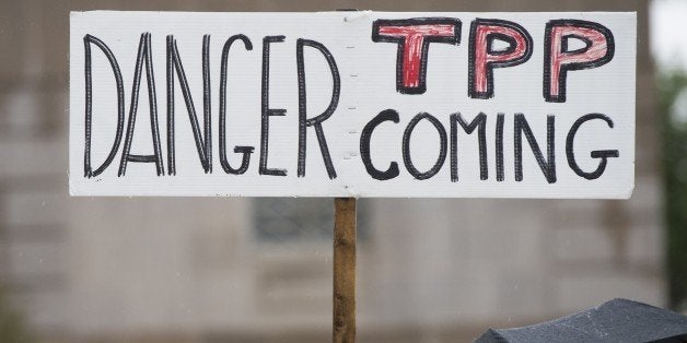 Demonstrators protest against the legislation to give US President Barack Obama fast-track authority to advance trade deals, including the Trans-Pacific Partnership (TPP), during a protest march on Capitol Hill in Washington, DC, May 21, 2015. The US Senate advanced the legislation on Thursday to give Obama fast-track authority to forge a huge Asia-Pacific trade accord, setting up a final vote in the chamber for later this week. The measure would allow the Obama administration to conclude negotiations with 11 other Pacific Rim nations and bring a trade accord to Congress for an up or down vote, with lawmakers not permitted to make changes. AFP PHOTO / SAUL LOEB (Photo credit should read SAUL LOEB/AFP/Getty Images)