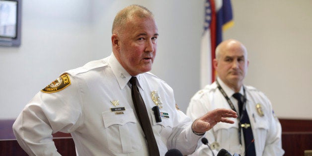 St. Louis County police Chief Jon Belmar, left, answers questions as Webster Groves police Captain Mike Nelson listens during