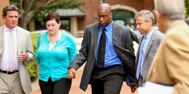 Former CIA officer Jeffrey Sterling, center, accompanied by his wife Holly, and his attorney, arrives at the U.S. District Court in Alexandria, Va., Monday, May 11, 2015. Sterling was scheduled for sentencing for leaking details of a secret mission to thwart Iran's nuclear ambitions. (AP Photo/Andrew Harnik)