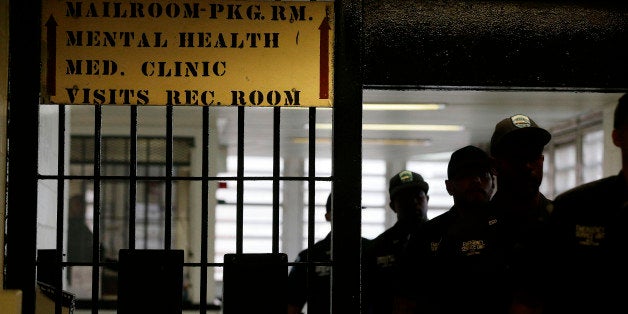 Rikers Island emergency services personnel walk through one of many gates inside the jail's juvenile detention facility, Thursday, July 31, 2014, in New York. (AP Photo/Julie Jacobson)