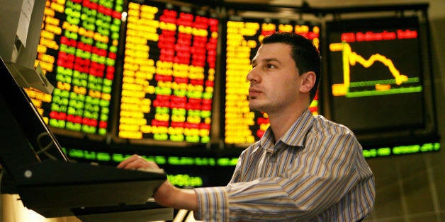 Melbourne, AUSTRALIA: Matthew Nassrawi studies movements at the Australian Stock Exchange in Melbourne, 16 May 2006, as Australian share prices fell 0.32 percent due to a sell-off in resources and energy stocks triggered by an overnight correction in commodity prices but the market's fall was limited by gains in banking and insurance shares. The benchmark S and P/ASX 200 closed down 16.7 points at 5,217.4 while the broader All Ordinaries shed 21.2 ponts to end the day at 5,170.2. AFP PHOTO/William WEST (Photo credit should read WILLIAM WEST/AFP/Getty Images)