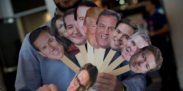 Adam Gabbatt of The Guardian newspaper holds images of possible Republican candidates, from left, former Penn. Sen. Rick Santorum, former Alaska Gov. Sarah Palin, Sen. Ted Cruz, R-Texas, Wisconsin Gov. Scott Walker, Donald Trump, New Jersey Gov. Chris Christie, Sen. Marco Rubio, R-Fla., former Florida Gov. Jeb Bush, Sen. Rand Paul, R-Ky., and below, former Texas Gov. Rick Perry, as he interviews Howard "Cowboy" Woodward holds images during the Conservative Political Action Conference (CPAC) in National Harbor, Md., Thursday, Feb. 26, 2015. (AP Photo/Carolyn Kaster)