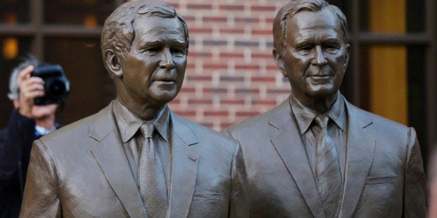 Statues of former Presidents George W. Bush, left and George HW Bush are seen during a tour of the George W. Bush Presidential Center Wednesday, April 24, 2013, in Dallas. (AP Photo/David J. Phillip)