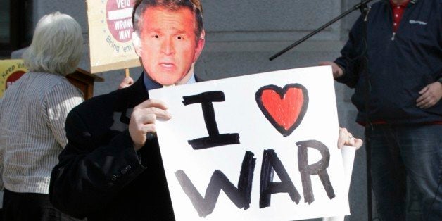A man wearing a George Bush mask walks through the courtyard of Philadelphia's City Hall during a protest against the war in
