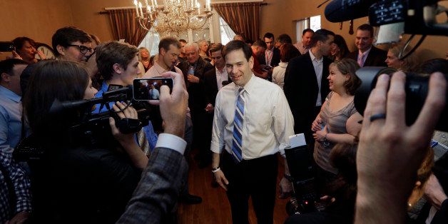 Republican presidential candidate, Sen. Marco Rubio, R-Fla., mingles with potential voters at a campaign house party, Friday, April 17, 2015, in Manchester, N.H. (AP Photo/Elise Amendola)