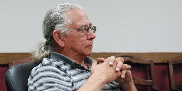 O.J. Semans, of Rosebud, S.D., with the voting advocacy organization Four Directions Inc., listens Wednesday, July 31, 2013, in Pierre, S.D., as the South Dakota Election Board discusses a proposal to use federal money to set up satellite voter registration and absentee voting offices on three American Indian reservations. The board declined to support the proposal after members said they first need to find out whether a federal agency will allow the spending for the offices. (AP Photo/Chet Brokaw)