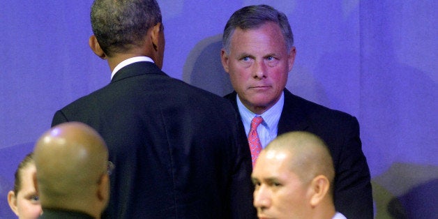 CHARLOTTE, NC - AUGUST 26: U.S. Senator Richard Burr (R-NC), looks at President Barack Obama following his speech at the American Legion National Convention on August 26, 2014 in Charlotte, North Carolina. Obama announced a series of executive actions to aid veterans. (Photo by Sara D. Davis/Getty Images)