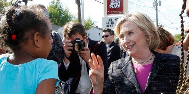 Democratic presidential candidate Hillary Rodham Clinton talks with customers during a stop for ice cream at Moo's Place, Friday, May 22, 2015, in Derry, N.H. (AP Photo/Jim Cole)