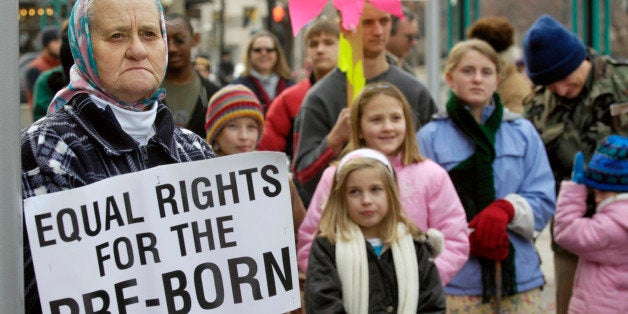 Virginia Bayes of Wilder, Idaho, left, holds her sign in a crowd of about 250 outside the the Boise City Hall where Right to Life of Idaho held the March for Life rally Saturday, Jan. 19, 2008, to mark the 35th year of legalized abortion in the United States. (AP Photo/Idaho Press-Tribune, Greg Kreller) **MANDATORY CREDIT: GREG KRELLER/IDAHO PRESS-TRIBUNE, ONLINE USE OK**