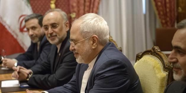Head of the Iranian Atomic Energy Organization Ali Akbar Salehi, 2nd left, and Iranian Foreign Minister Javad Zarif, center, wait at the start of a meeting at the Beau Rivage Palace Hotel, in Lausanne, Switzerland, Saturday March 28, 2015. Negotiations over Iran's nuclear program picked up pace on Saturday with the foreign ministers of France and Germany joining U.S. Secretary of State John Kerry in talks with Iran's top diplomat ahead of a looming end-of-March deadline for a preliminary deal. (AP Photo/Brendan Smialowski, Pool)