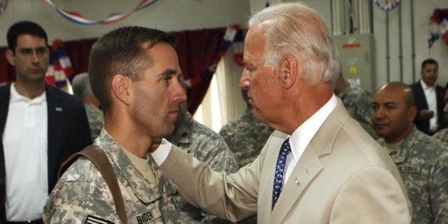 U.S. Vice President Joe Biden, right, talks with his son, U.S. Army Capt. Beau Biden (L), at Camp Victory on the outskirts of Baghdad, Saturday, July 4, 2009. US Vice President Joe Biden said today that America's role in Iraq was switching from deep military engagement to one of diplomatic support, ahead of a complete withdrawal from the country in 2011. AFP PHOTO/ POOL/ KHALID MOHAMMED (Photo credit should read KHALID MOHAMMED/AFP/Getty Images)