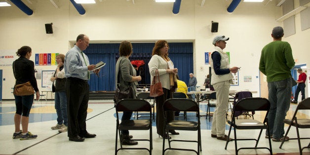 CHARLOTTE, NC - NOVEMBER 4: People stand in line to vote on November 4, 2014, in Cotswold School's gymnasium in Charlotte, North Carolina. Americans head to the polls to cast their vote in the mid-term elections which will ultimately decide what party controls the U.S. Senate. (Photo by Davis Turner/Getty Images) (Photo by Davis Turner/Getty Images)