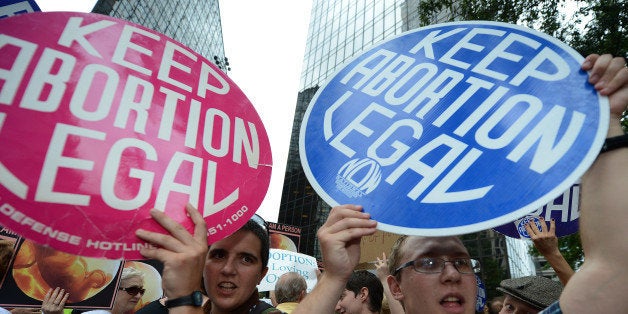 Abortion rights activists shout slogans on day two of the Democratic National Convention (DNC), in Charlotte, North Carolina on September 5, 2012. President Barack Obama's nomination acceptance speech, originally schecduled to take place at the Bank of America Stadium, will now take place indoors at the Time Warner Cable Arena because of concerns about severe weather, the Democratic National Convention Committee announced. PHOTO / ROBYN BECK (Photo credit should read ROBYN BECK/AFP/GettyImages)