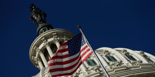 WASHINGTON, DC - SEPTEMBER 29: An American flag waves outside the United States Capitol building as Congress remains gridloc