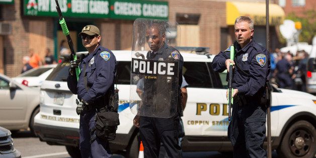 BALTIMORE, MD - MAY 4: Police form a line to block North Ave., near the site of recent riots and several blocks away from where Freddie Gray was arrested last month, May 4, 2015 in Baltimore, Maryland. Initial reports that a man had been shot by police sparked anger in the crowd. Officials later reported that no one had been injured and the gun, carried by a man seen on a security camera, had discharged accidentally. (Photo by Allison Shelley/Getty Images)