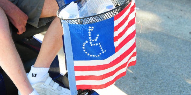 A member of ADAPT, a disability rights group, passes the White House during a protest April 27, 2009 in Washington, DC. The g