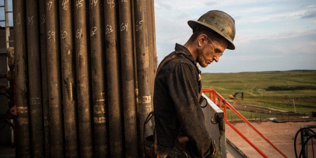 WATFORD CITY, ND - JULY 28: Ray Gerish, a floor hand for Raven Drilling, works on an oil rig drilling into the Bakken shale formation on July 28, 2013 outside Watford City, North Dakota. North Dakota has been experiencing an oil boom in recent years, due in part to new drilling techniques including hydraulic fracturing and horizontal drilling. In April 2013, The United States Geological Survey released a new study estimating the Bakken formation and surrounding oil fields could yield up to 7.4 billion barrels of oil, doubling their estimate of 2008, which was stated at 3.65 billion barrels of oil. Workers for Raven Drilling work twelve hour days fourteen days straight, staying at a camp nearby, followed by fourteen days. (Photo by Andrew Burton/Getty Images)