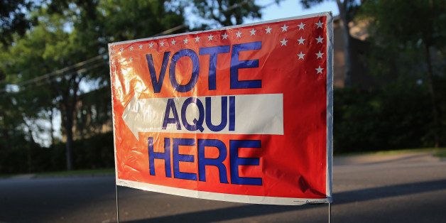 AUSTIN, TX - APRIL 28: A bilingual sign stands outside a polling center at public library ahead of local elections on April 28, 2013 in Austin, Texas. Early voting was due to begin Monday ahead of May 11 statewide county elections. The Democratic and Republican parties are vying for the Latino vote nationwide following President Obama's landslide victory among Hispanic voters in the 2012 election. (Photo by John Moore/Getty Images)