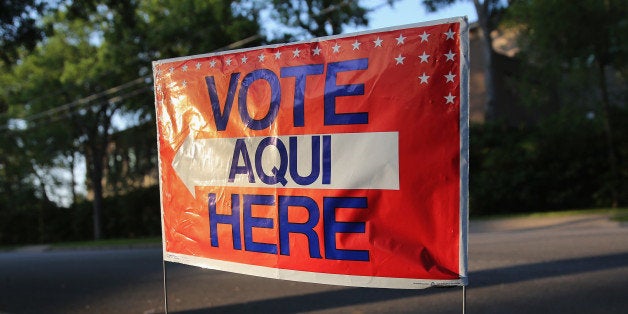 AUSTIN, TX - APRIL 28: A bilingual sign stands outside a polling center at public library ahead of local elections on April