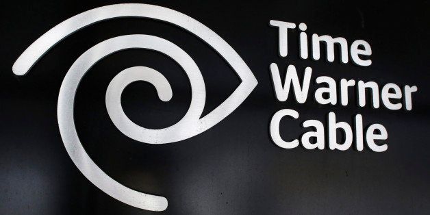 The Time Warner Cable corporate logo is displayed at a company store, Tuesday, May 26, 2015 in New York. Charter Communications is buying Time Warner Cable for $55.33 billion. And executives say they're confident regulators will allow the creation of another U.S. TV and Internet giant. (AP Photo/Mark Lennihan)